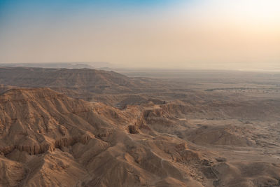 Scenic view of arid landscape against sky