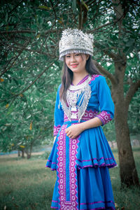 Portrait of smiling girl standing against plants