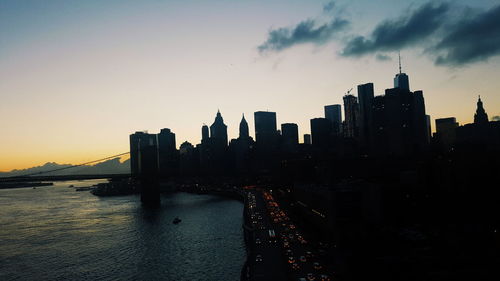 View of suspension bridge in city at dusk