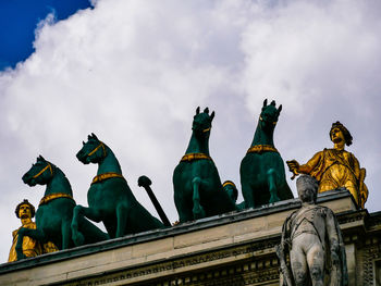 Low angle view of statue against sky