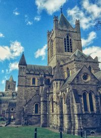 Low angle view of church against cloudy sky