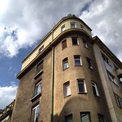 Low angle view of building against cloudy sky