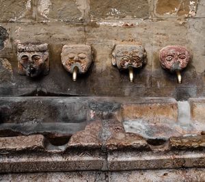 Statues on stone wall