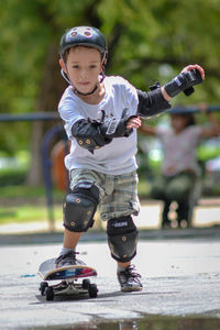 Full length of boy with arms raised