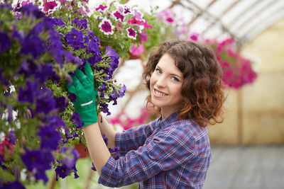 Close-up of woman by purple flowering plants