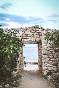 Built structure on beach against sky