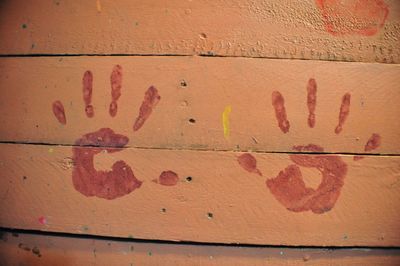 Close-up of hand prints on wall