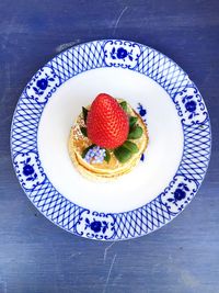 High angle view of strawberry pancake served on table
