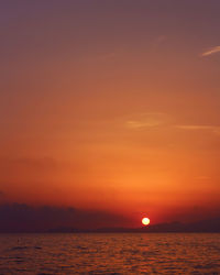 Scenic view of sea against orange sky