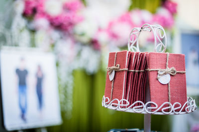 Close-up of pink flower hanging on table