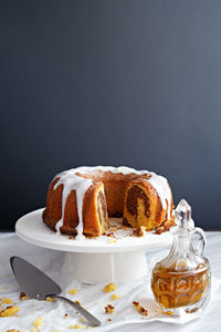 Close-up of cake on table against black background