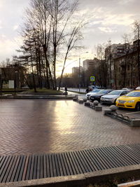 Cars on road against sky in city