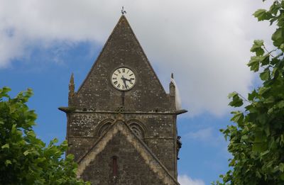 Low angle view of clock tower against sky