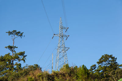 Low angle view of electricity pylon against sky