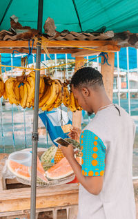 Side view of a boy holding food