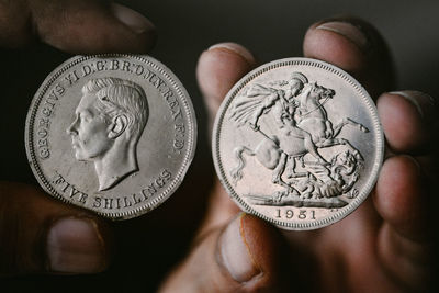 Close-up of hand holding vintage coins