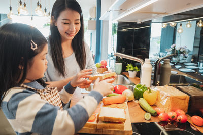 Young woman preparing food at home