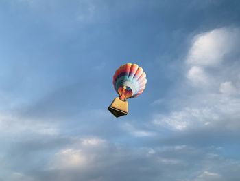 Low angle view of person in hot air balloon against sky