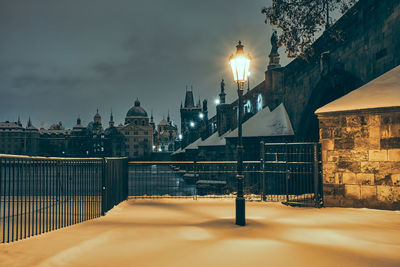 Illuminated street light in city at night