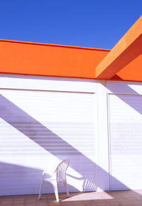 Stylish location in the city wallpaper. minimal, geometry and shadows. wall and chair