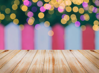 Close-up of multi colored lights on wooden table