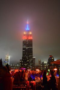 Low angle view of illuminated empire state building in city at night