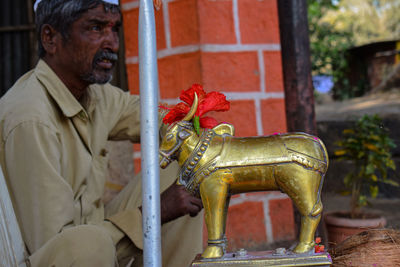 Statue of man holding sculpture