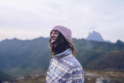 Portrait of woman standing against mountain