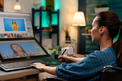 Woman sitting on table at home