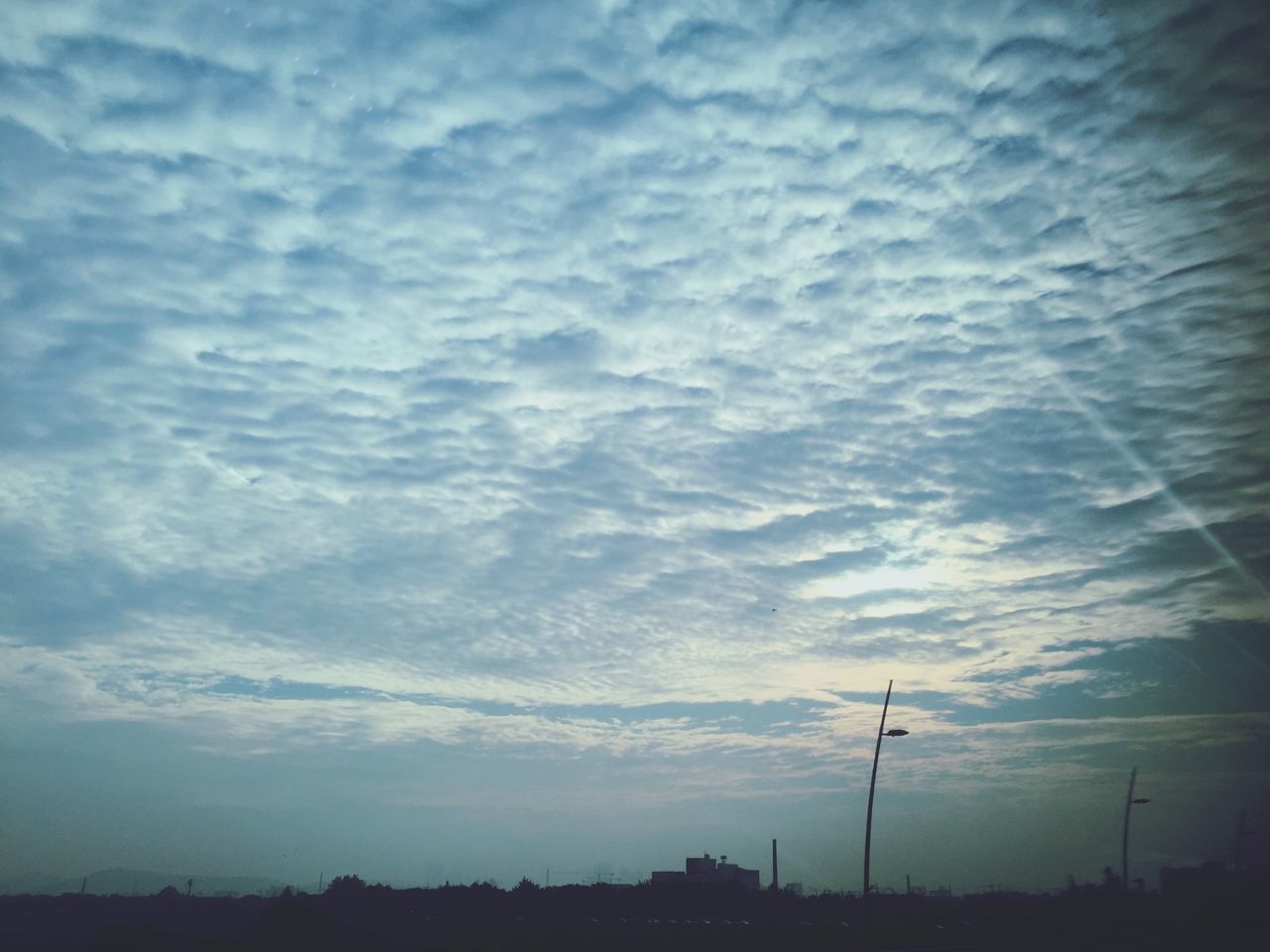 sky, cloud - sky, low angle view, cloudy, silhouette, tranquility, weather, beauty in nature, cloud, scenics, nature, tranquil scene, overcast, dusk, street light, electricity pylon, outdoors, power line, electricity, no people