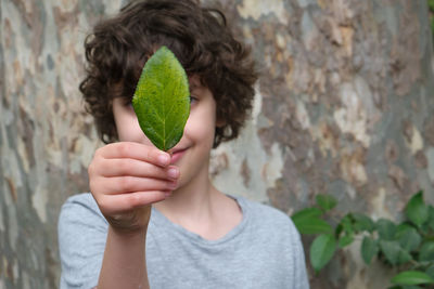 Portrait of woman holding plant