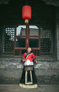 Young woman standing outside temple