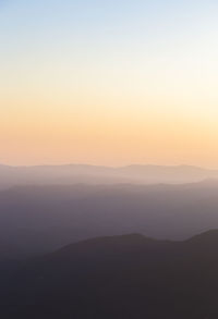 Scenic view of silhouette mountains against sky during sunset