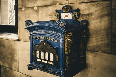 Close-up of mailbox on tiled wall