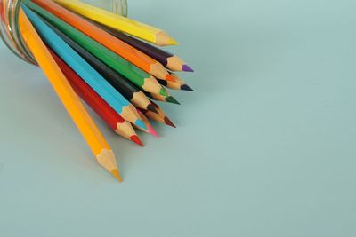 High angle view of colored pencils on white background
