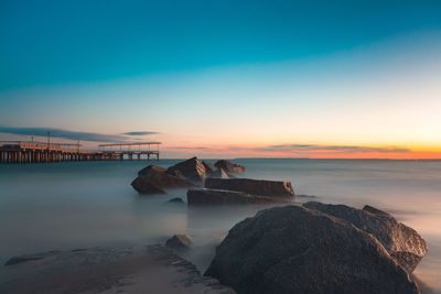 Scenic view of sea against sky at sunset