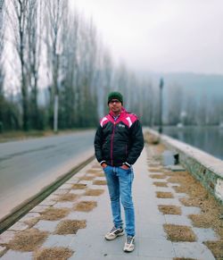 Portrait of young man standing in snow