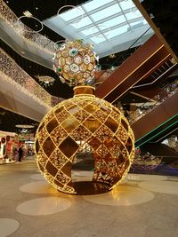 Low angle view of illuminated chandelier in shopping mall