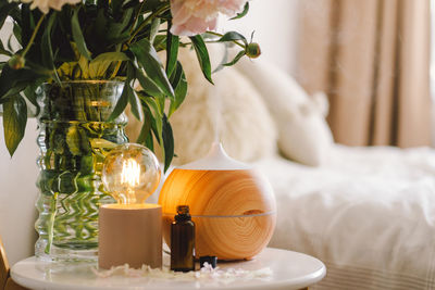 Aroma oil diffuser on chair against in the bedroom. air freshener.