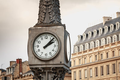 Low angle view of clock tower against sky in city