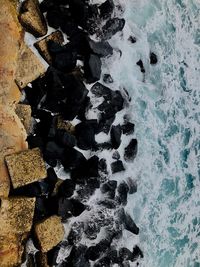 High angle view of rocks by sea