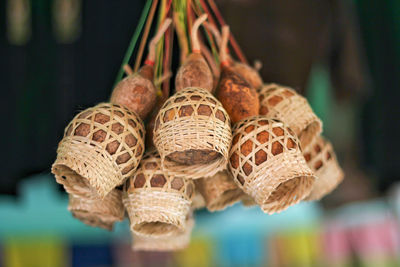 Low angle view of food in whicker basket hanging from ceiling