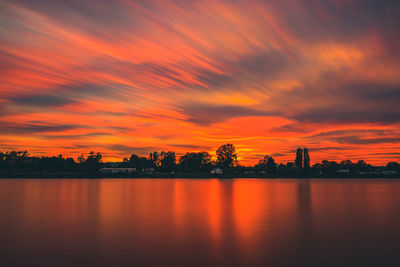 Scenic view of silhouette trees against orange sky