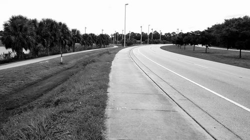 Empty road along trees