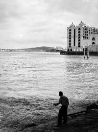 High angle view of man fishing in sea