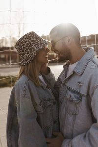 Girlfriend and boyfriend in the fence looking each other and laughing. happy couple.