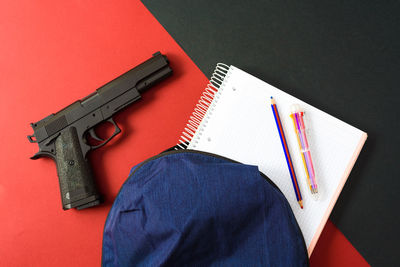 High angle view of gun against yellow background