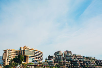 Low angle view of buildings against blue sky