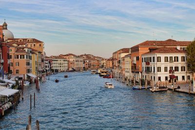 Canal passing through buildings in city