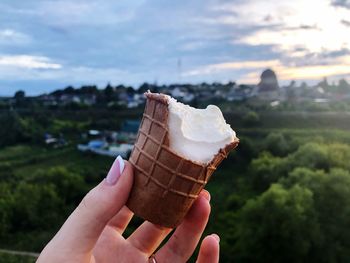 Close-up of hand holding ice cream cone